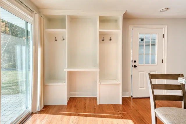 a view of a bedroom with wooden floor and windows