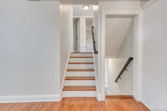 a view of entryway with wooden floor and stairs