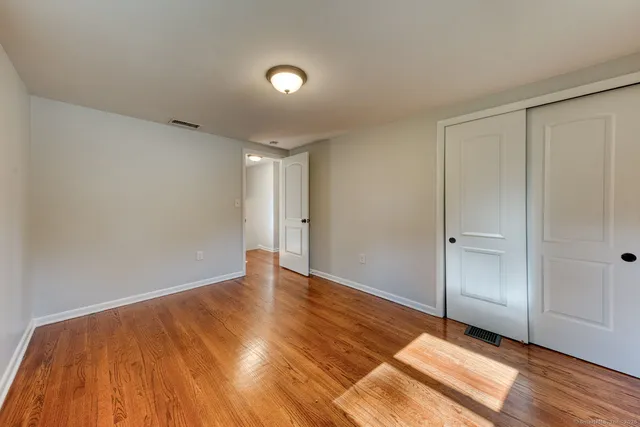 a view of an empty room and wooden floor