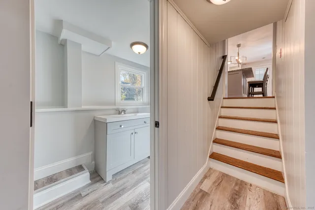 a view of a hallway with wooden floor and entryway