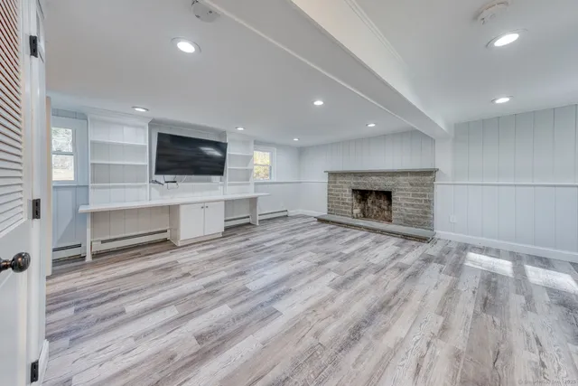 a living room with furniture a flat screen tv and a fireplace