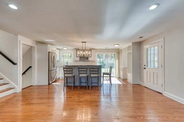 a dining room with furniture and wooden floor