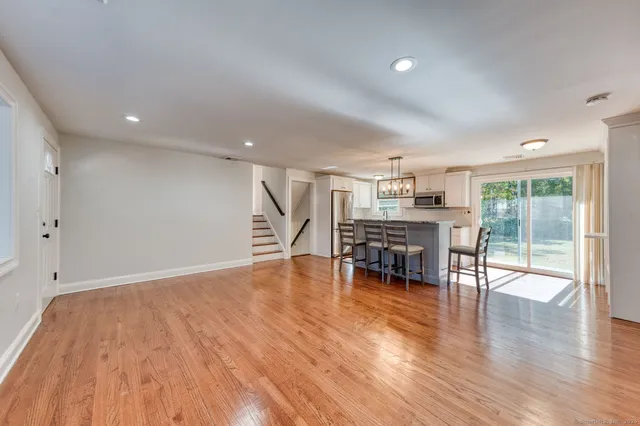 a view of kitchen with furniture and wooden floor