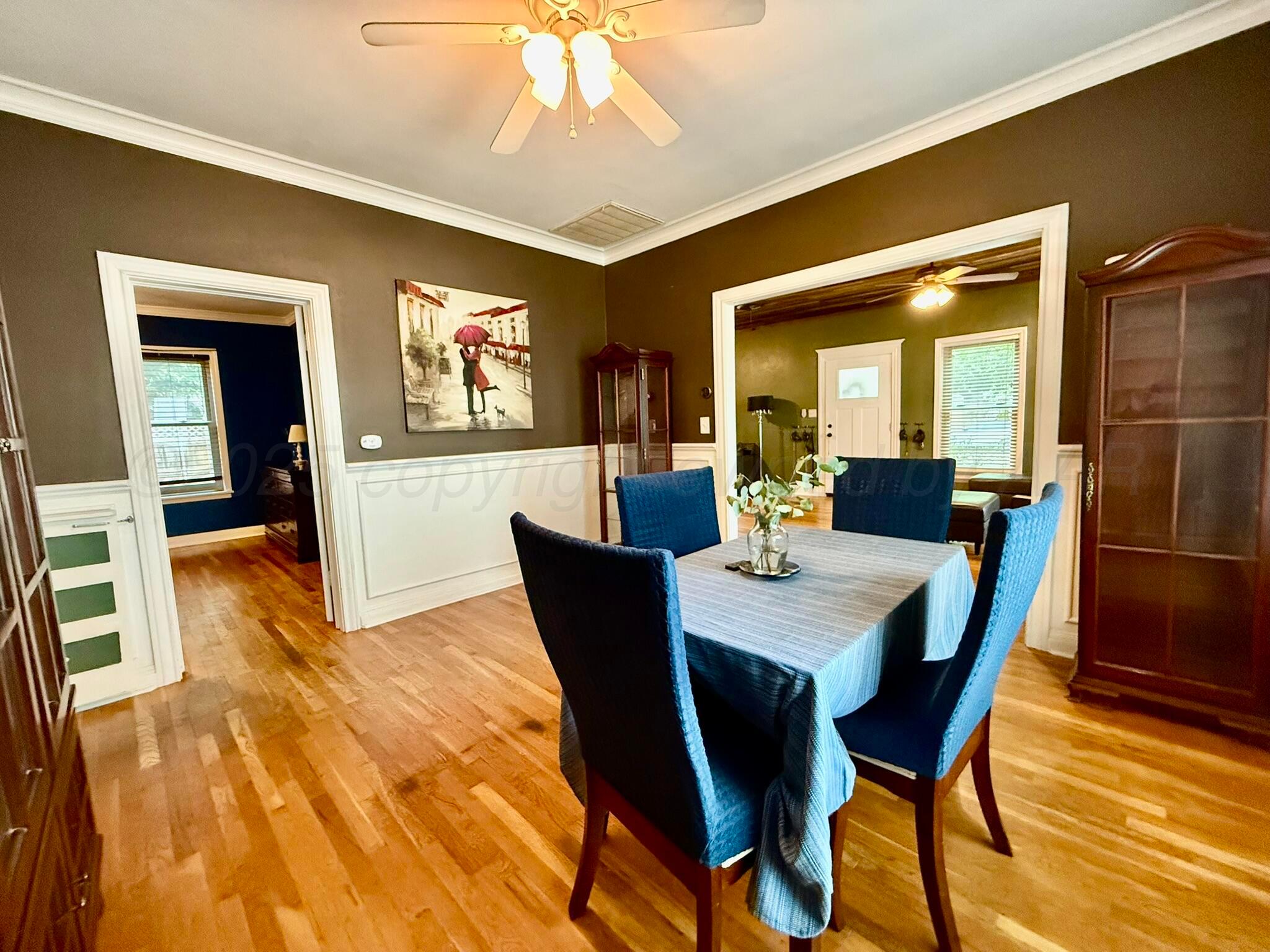 3314 Kingston Road Amarillo, TX 79106 - Photo 6 of 17 a view of a dining room with furniture a chandelier and wooden floor