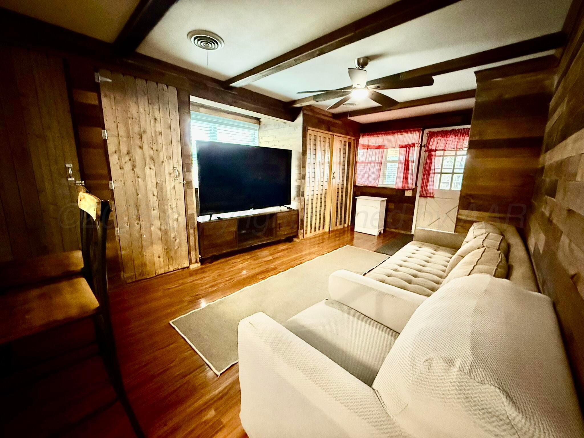 3314 Kingston Road Amarillo, TX 79106 - Photo 8 of 17 a living room with furniture and a flat screen tv