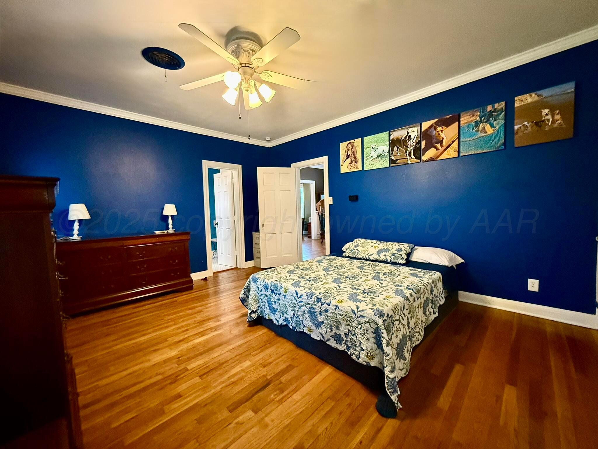 3314 Kingston Road Amarillo, TX 79106 - Photo 9 of 17 a bedroom with a bed and a chandelier