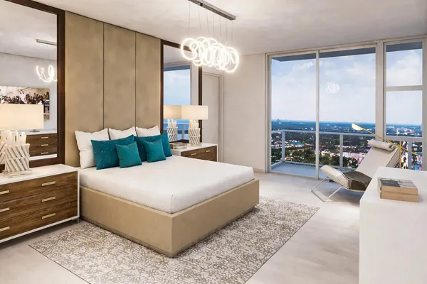 a bedroom with a large bed and a chandelier