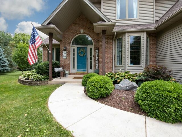 a front view of a house with garden