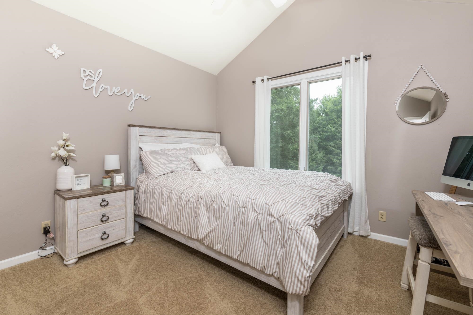 10023 Tybow Trail Roscoe, IL 61073 - Photo 17 of 20 a bed sitting in a bedroom next to a window