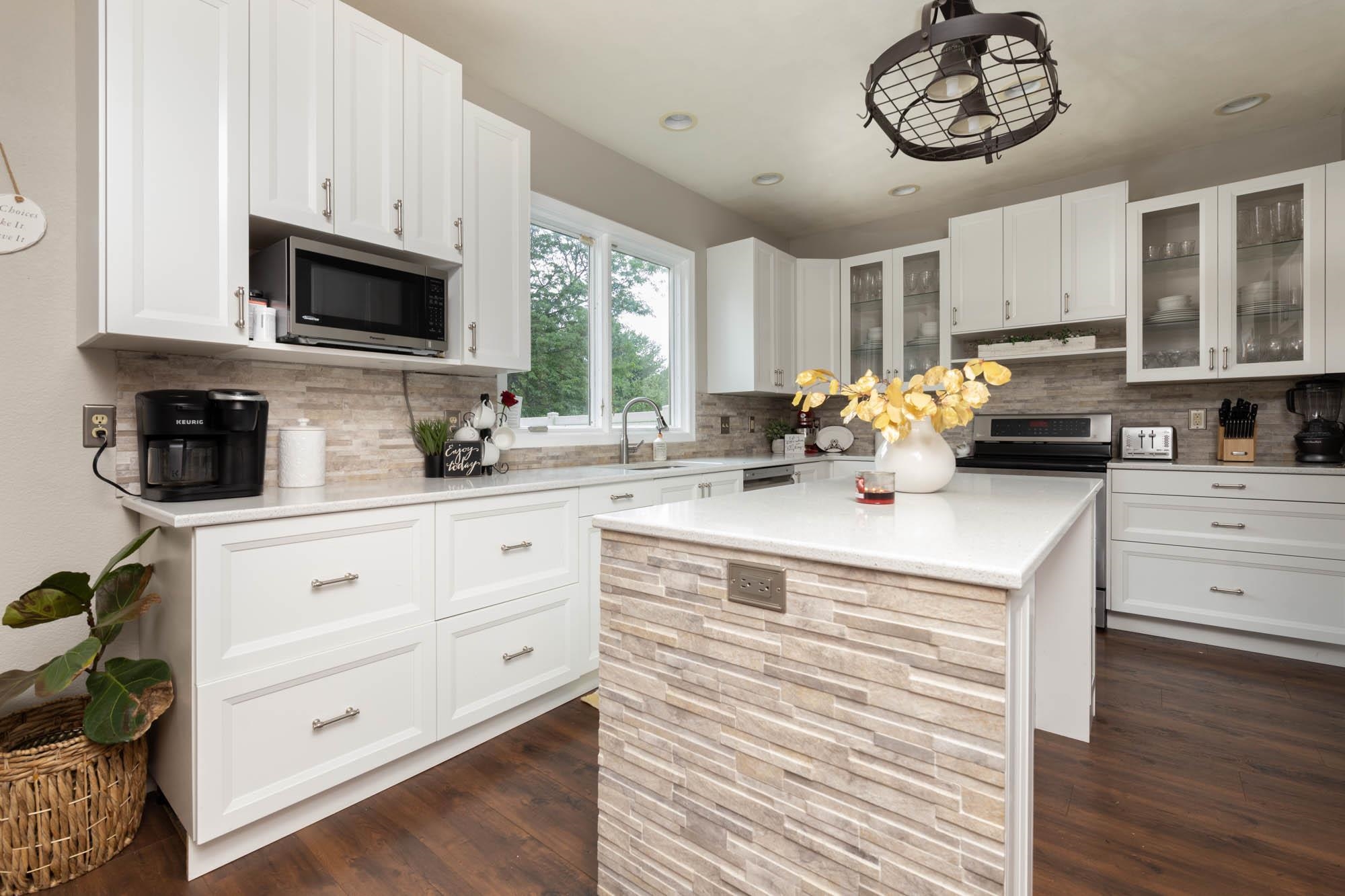 10023 Tybow Trail Roscoe, IL 61073 - Photo 6 of 20 a kitchen with a stove cabinets and a window