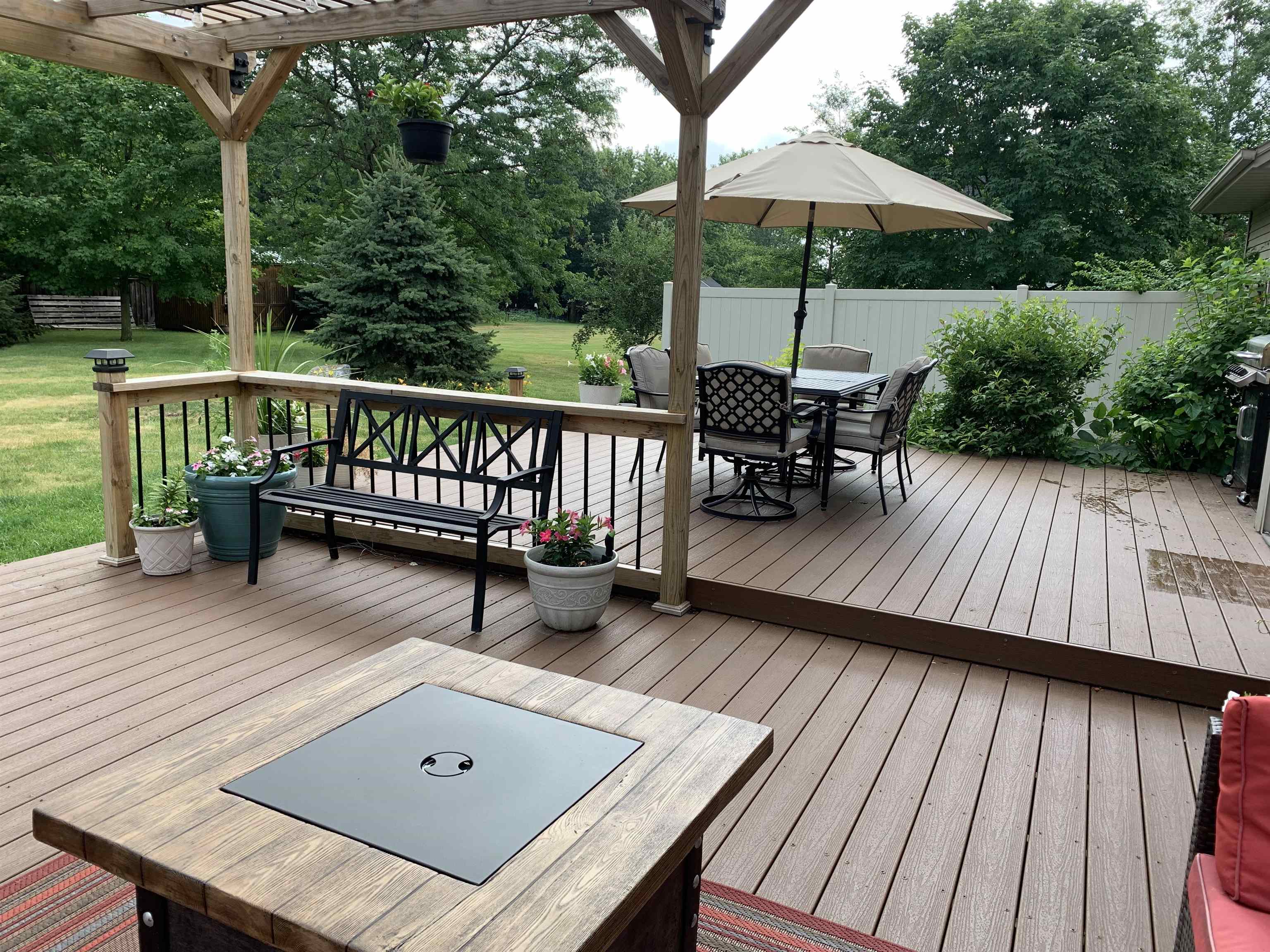 10023 Tybow Trail Roscoe, IL 61073 - Photo 7 of 20 a view of a wooden deck with furniture