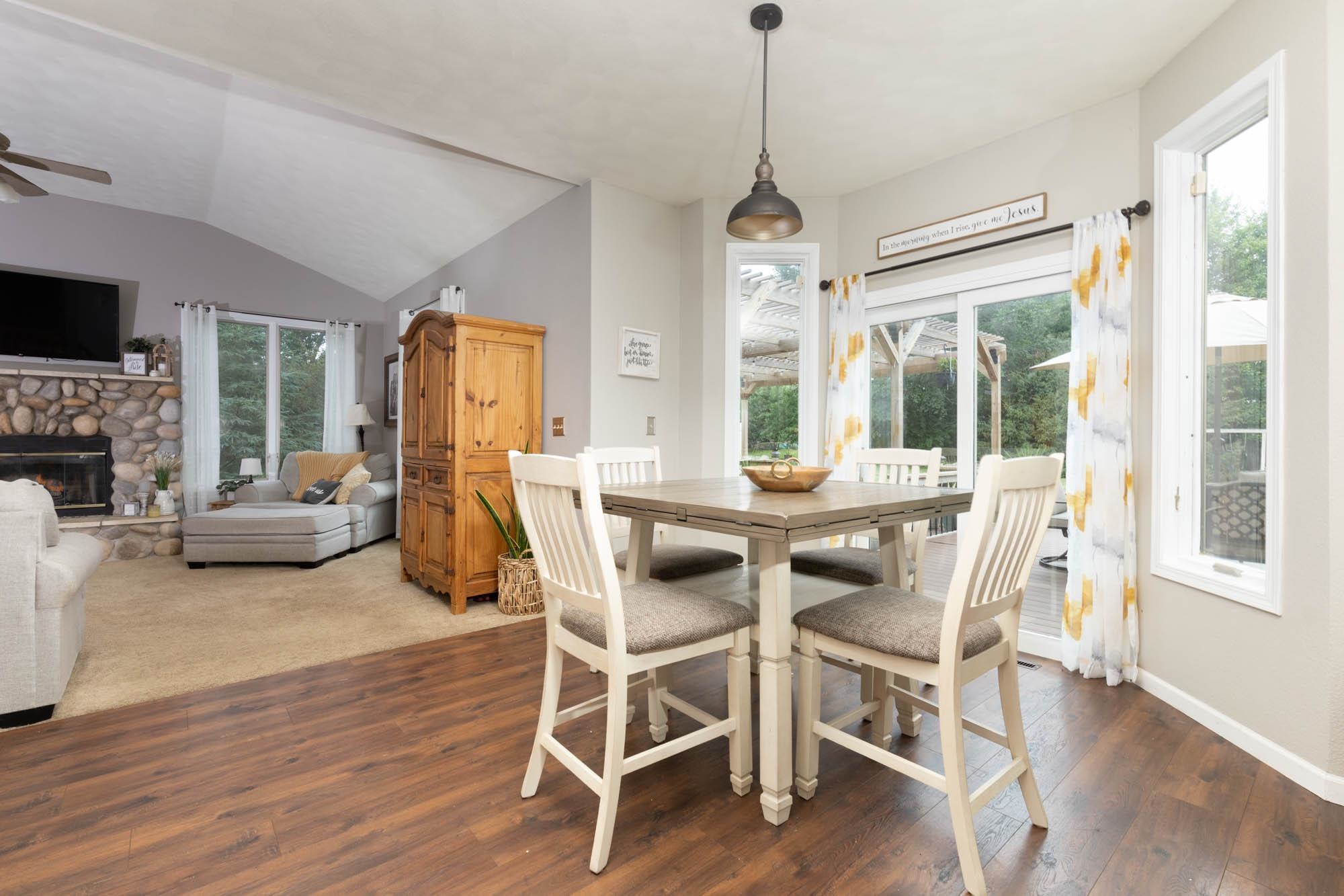 10023 Tybow Trail Roscoe, IL 61073 - Photo 10 of 20 a dining room with furniture a chandelier and wooden floor