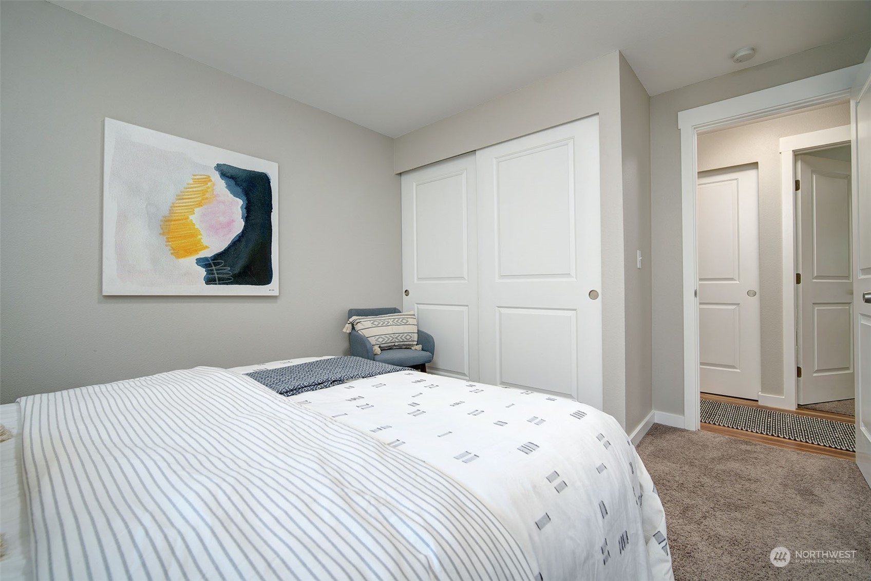 9504 233rd Street Southwest Edmonds, WA 98020 - Photo 19 of 26 a bedroom with a bed and a painting on the wall