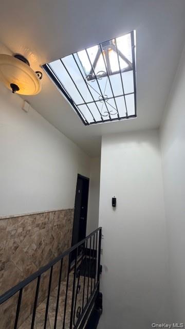 99-03 Northern Boulevard Queens, NY 11368 - Photo 4 of 7 Corridor featuring a skylight and an upstairs landing