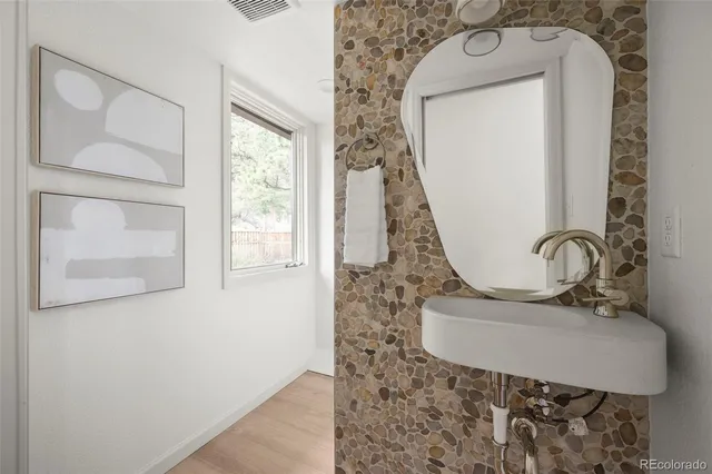 a bathroom with a sink and a mirror