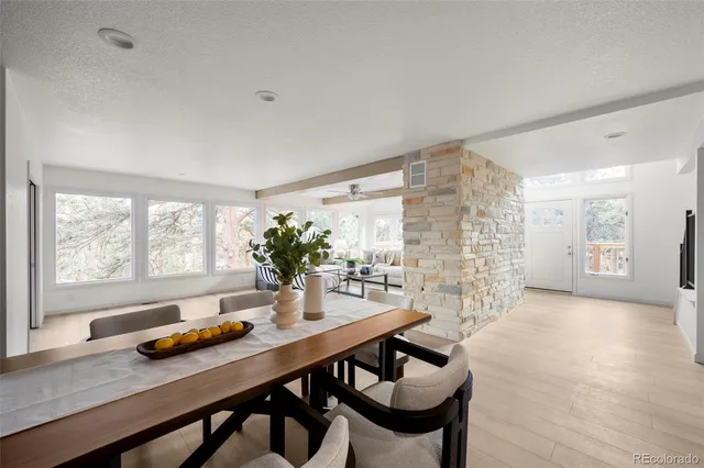a dining room with furniture and wooden floor