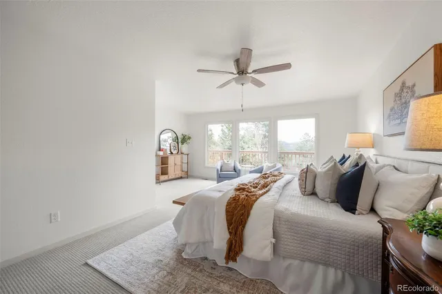 a bedroom with a bed a window and a chandelier