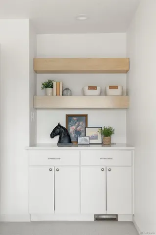 a shelf with a sink and cabinets