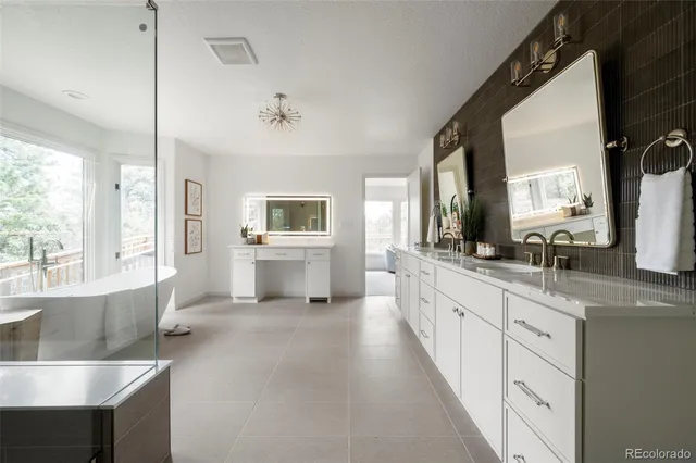 a large bathroom with a granite countertop sink mirror and a bathtub