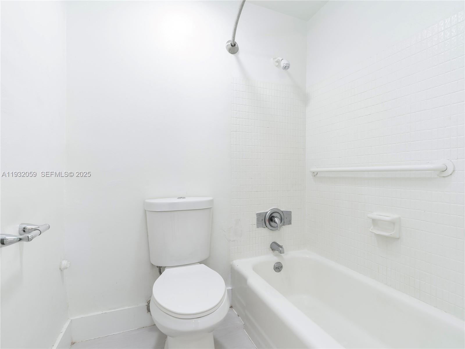 2025 Miami Road, Unit 17 Fort Lauderdale, FL 33316 - Photo 14 of 23 a white toilet sitting next to a bath tub