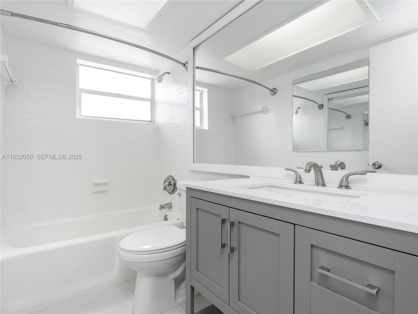 2025 Miami Road, Unit 17 Fort Lauderdale, FL 33316 - Photo 17 of 23 a bathroom with a granite countertop sink toilet and shower