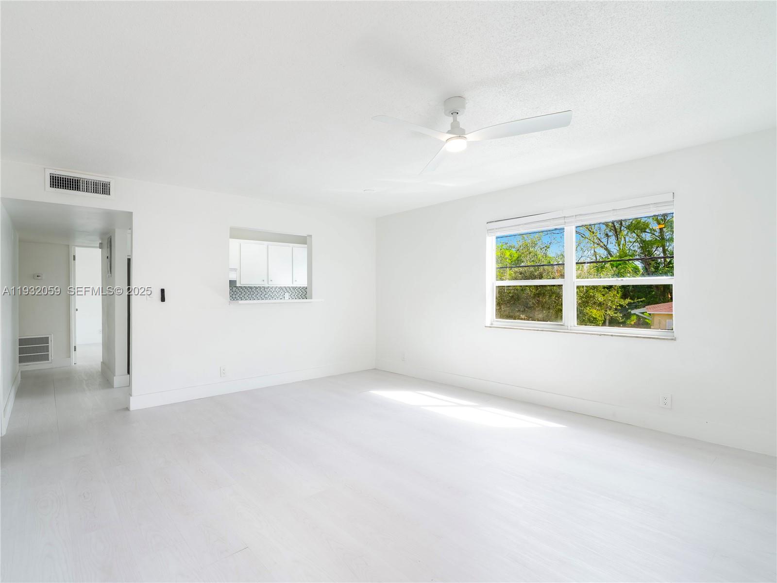 2025 Miami Road, Unit 17 Fort Lauderdale, FL 33316 - Photo 4 of 23 an empty room with windows and closet