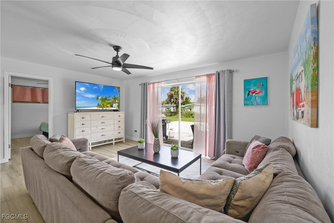 1661 Coronado Road Fort Myers, FL 33901 - Photo 12 of 50 a living room with a couch and a chandelier