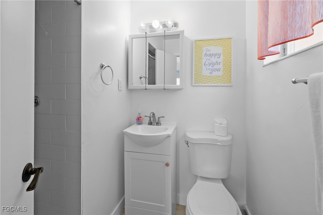 1661 Coronado Road Fort Myers, FL 33901 - Photo 15 of 50 a bathroom with a toilet sink and mirror