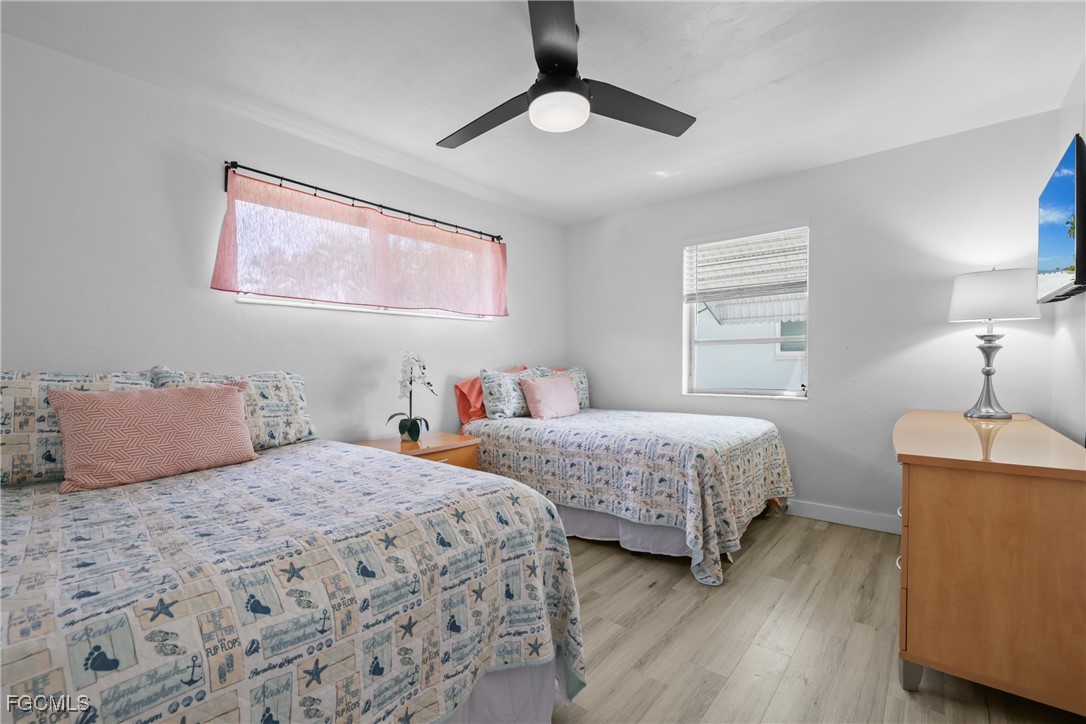 1661 Coronado Road Fort Myers, FL 33901 - Photo 18 of 50 a bedroom with two beds and painting on the wall