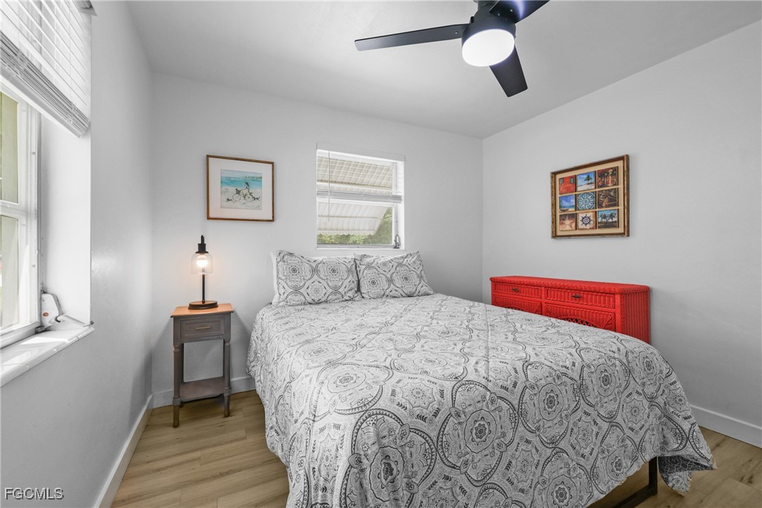 1661 Coronado Road Fort Myers, FL 33901 - Photo 22 of 50 a bedroom with a bed and a painting on the wall