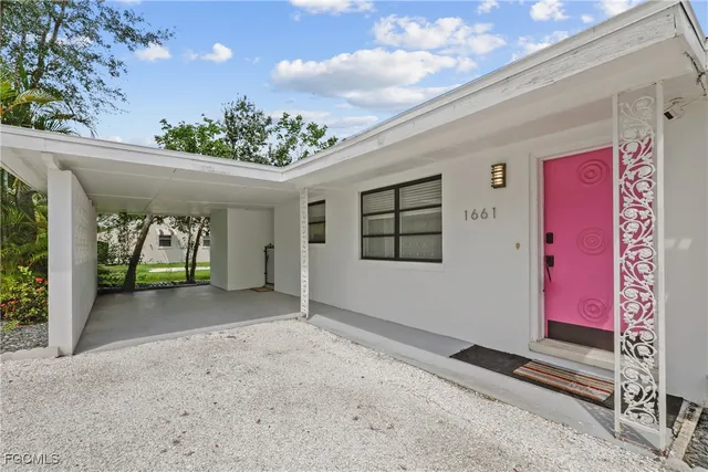 a view of a room with window and potted plants