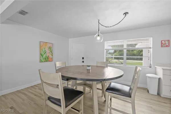 a dining room with furniture and wooden floor
