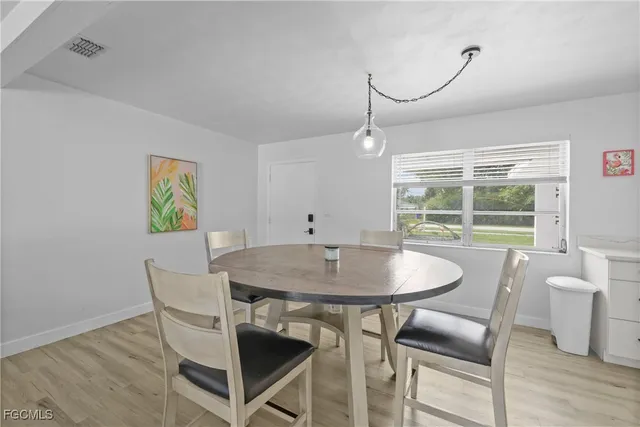 a dining room with furniture and wooden floor