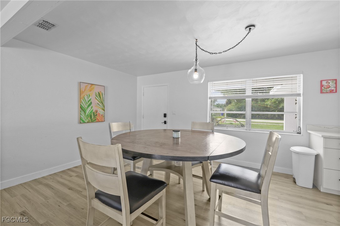 1661 Coronado Road Fort Myers, FL 33901 - Photo 3 of 50 a dining room with furniture and wooden floor