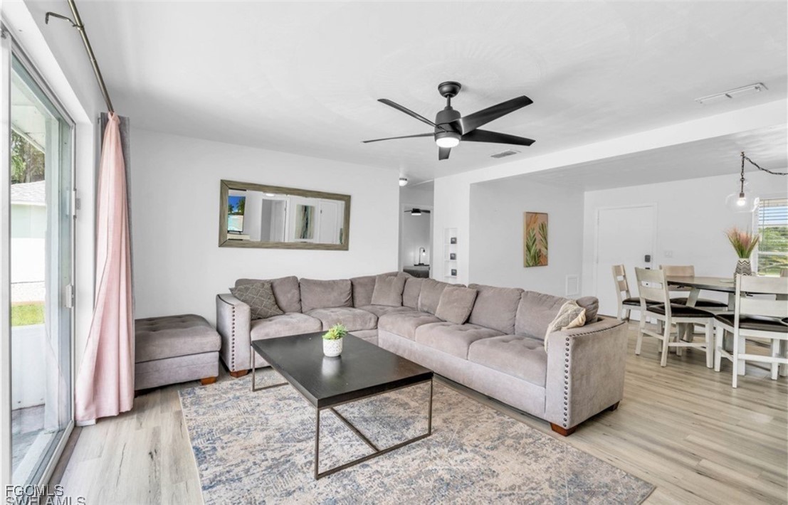 1661 Coronado Road Fort Myers, FL 33901 - Photo 34 of 50 a living room with furniture and a wooden floor