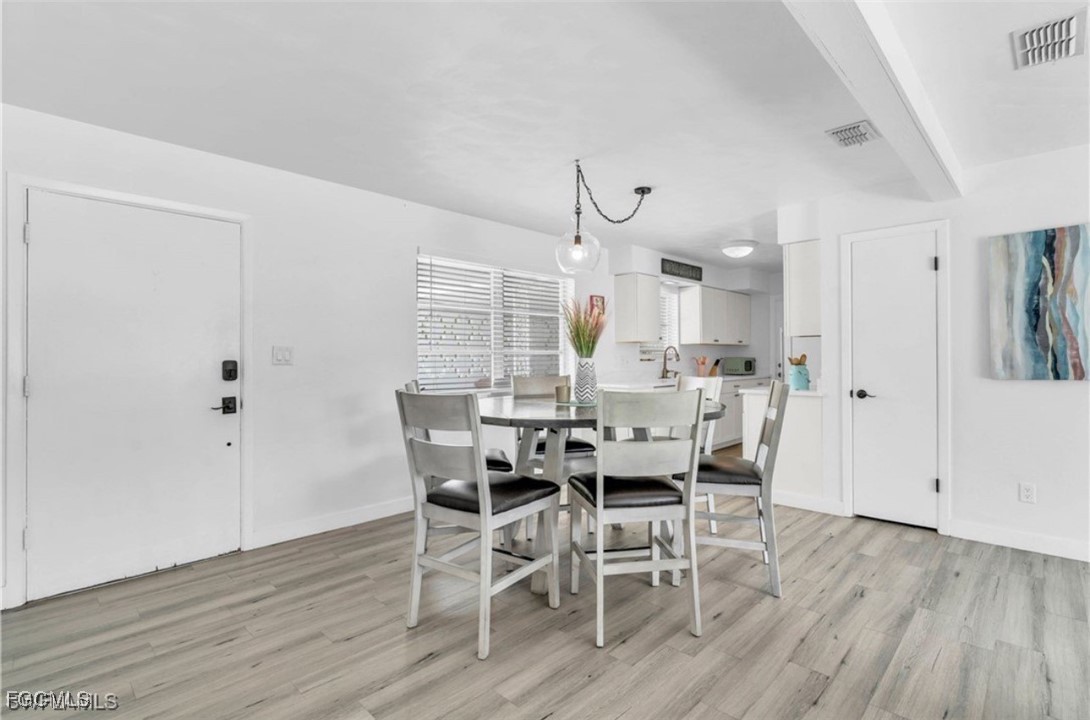1661 Coronado Road Fort Myers, FL 33901 - Photo 35 of 50 a view of a dining room with furniture and wooden floor