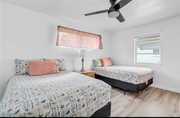 a bedroom with two beds and a window