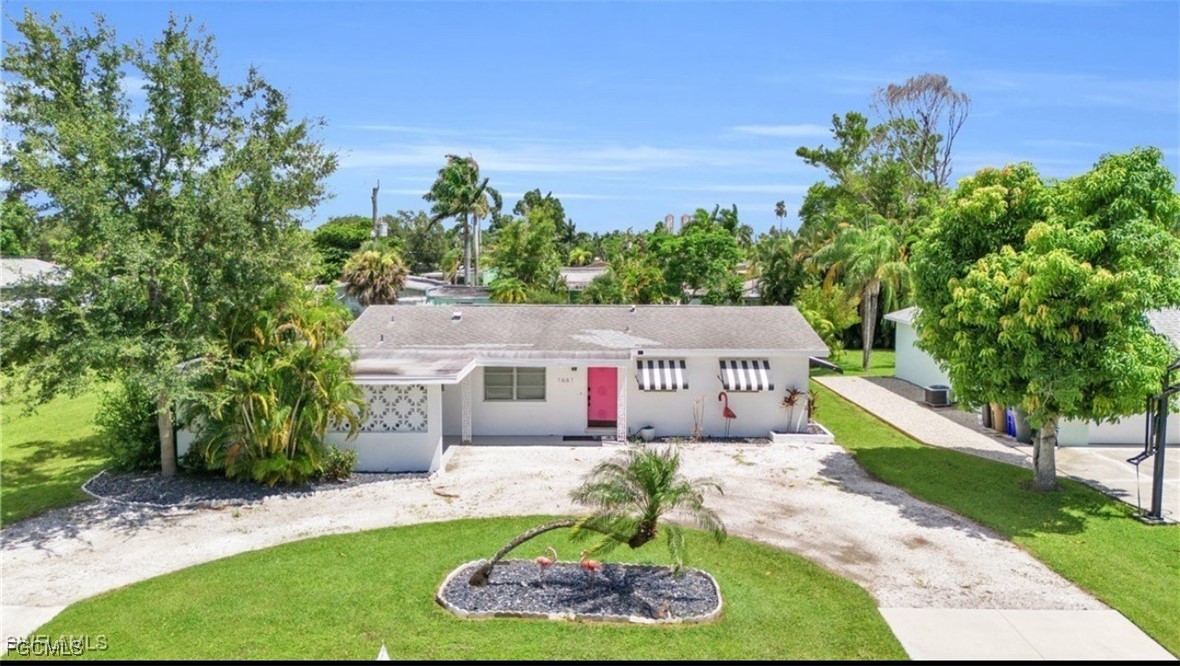 1661 Coronado Road Fort Myers, FL 33901 - Photo 48 of 50 a front view of a house with a yard