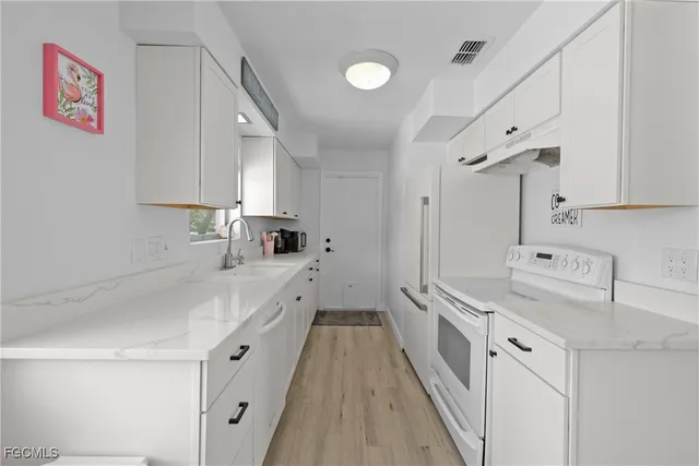 a kitchen with cabinets and a sink
