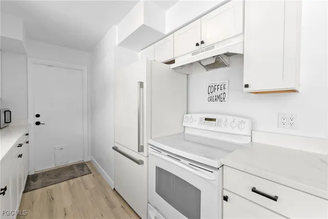 a view of a kitchen with cabinets