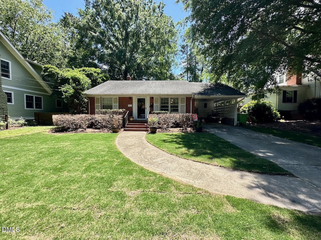 2813 Barmettler Street Raleigh, NC 27607 - Photo 2 of 22 front view of a house with a yard patio and fire pit