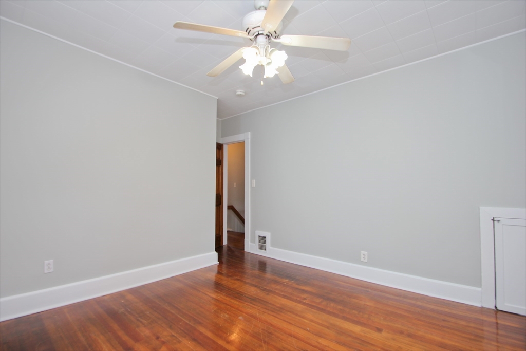 38 Virginia Street Springfield, MA 01108 - Photo 21 of 42 an empty room with wooden floor and fan