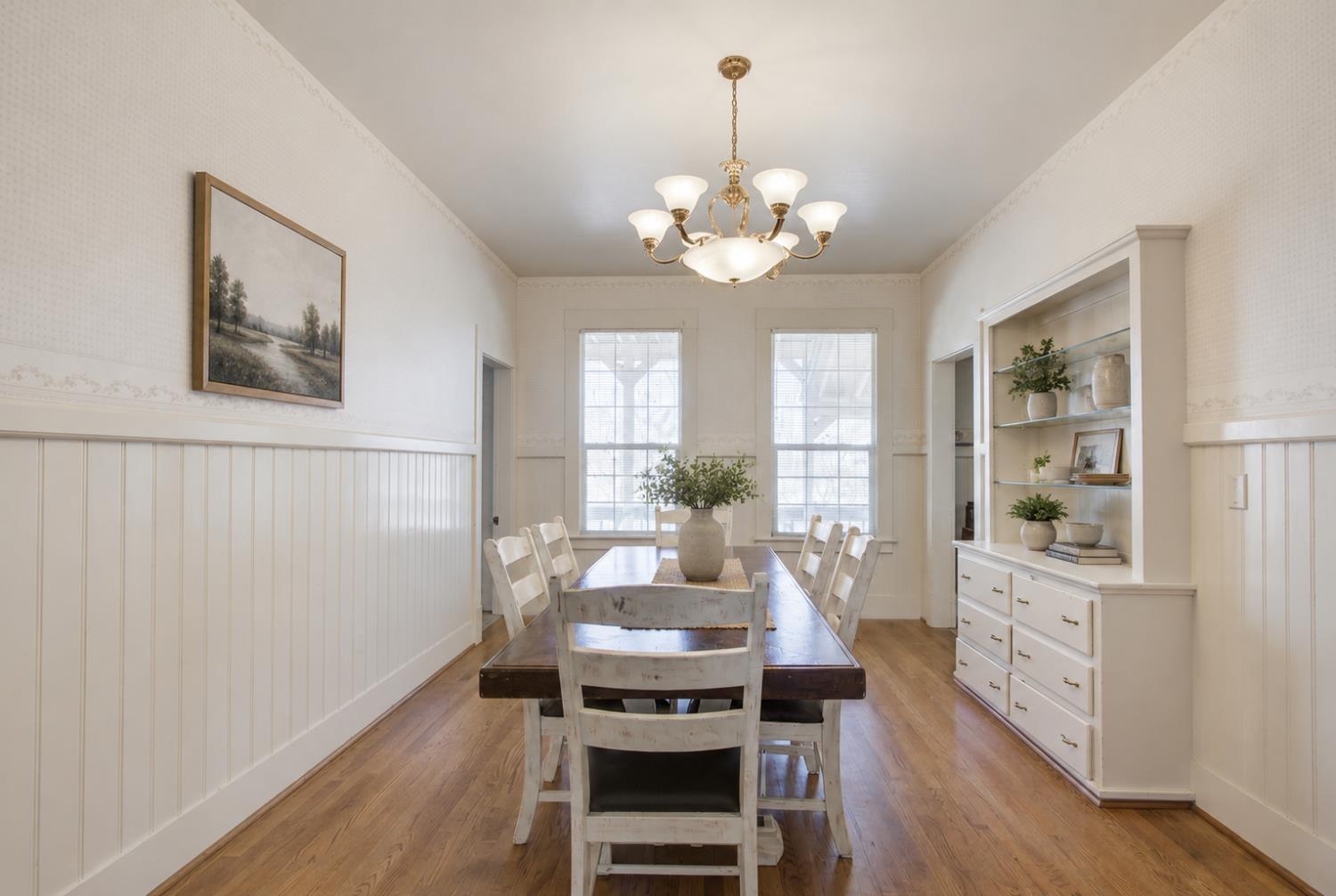 1100 Cold Springs Road Placerville, CA 95667 - Photo 97 of 97 Victorian Home - Dining area featuring wood-finish flooring, white wainscoting, and a built-in hutch with open shelving