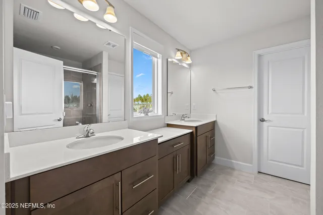 a bathroom with a sink double vanity and a mirror