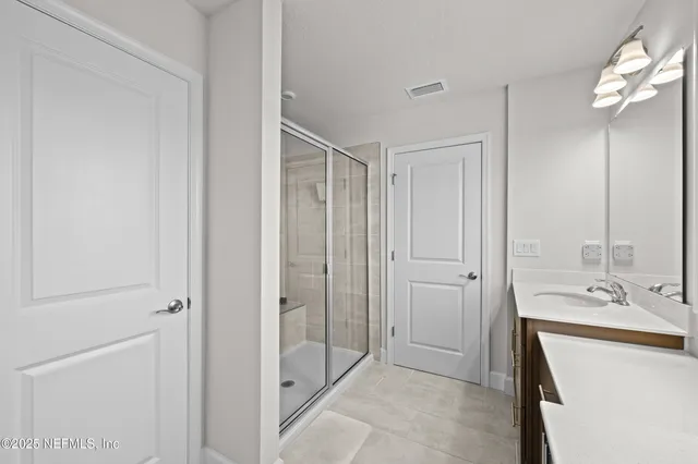 a bathroom with a sink a mirror and a shower