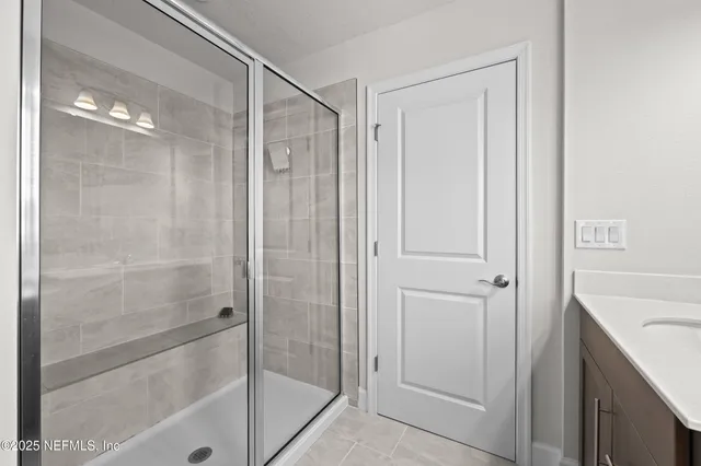 a bathroom with a shower and a sink