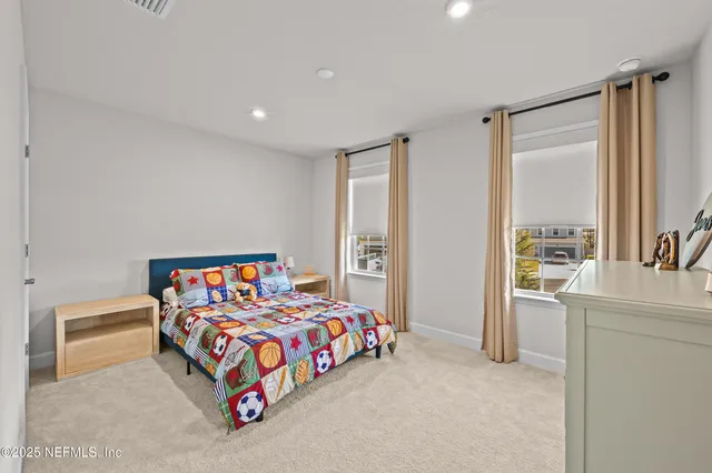 a bedroom with bed and a large window