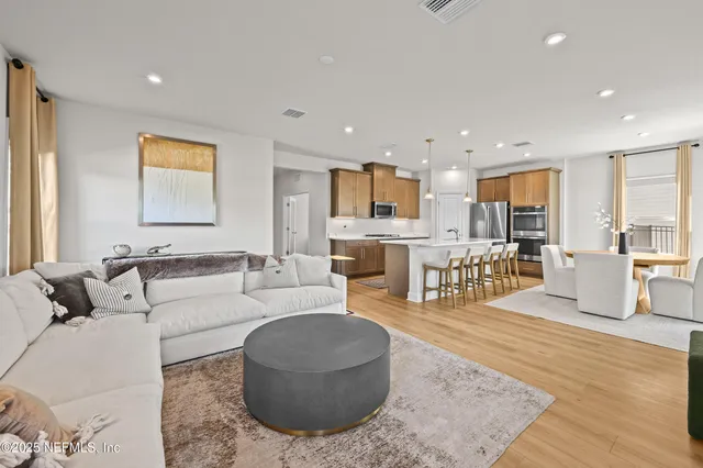 a living room with furniture and kitchen view