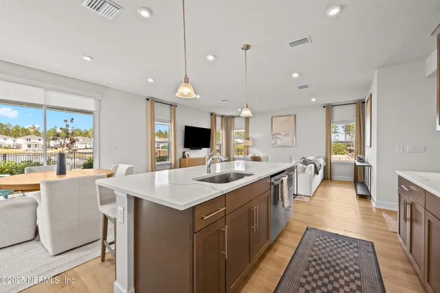 a kitchen with counter top space a sink appliances and cabinets