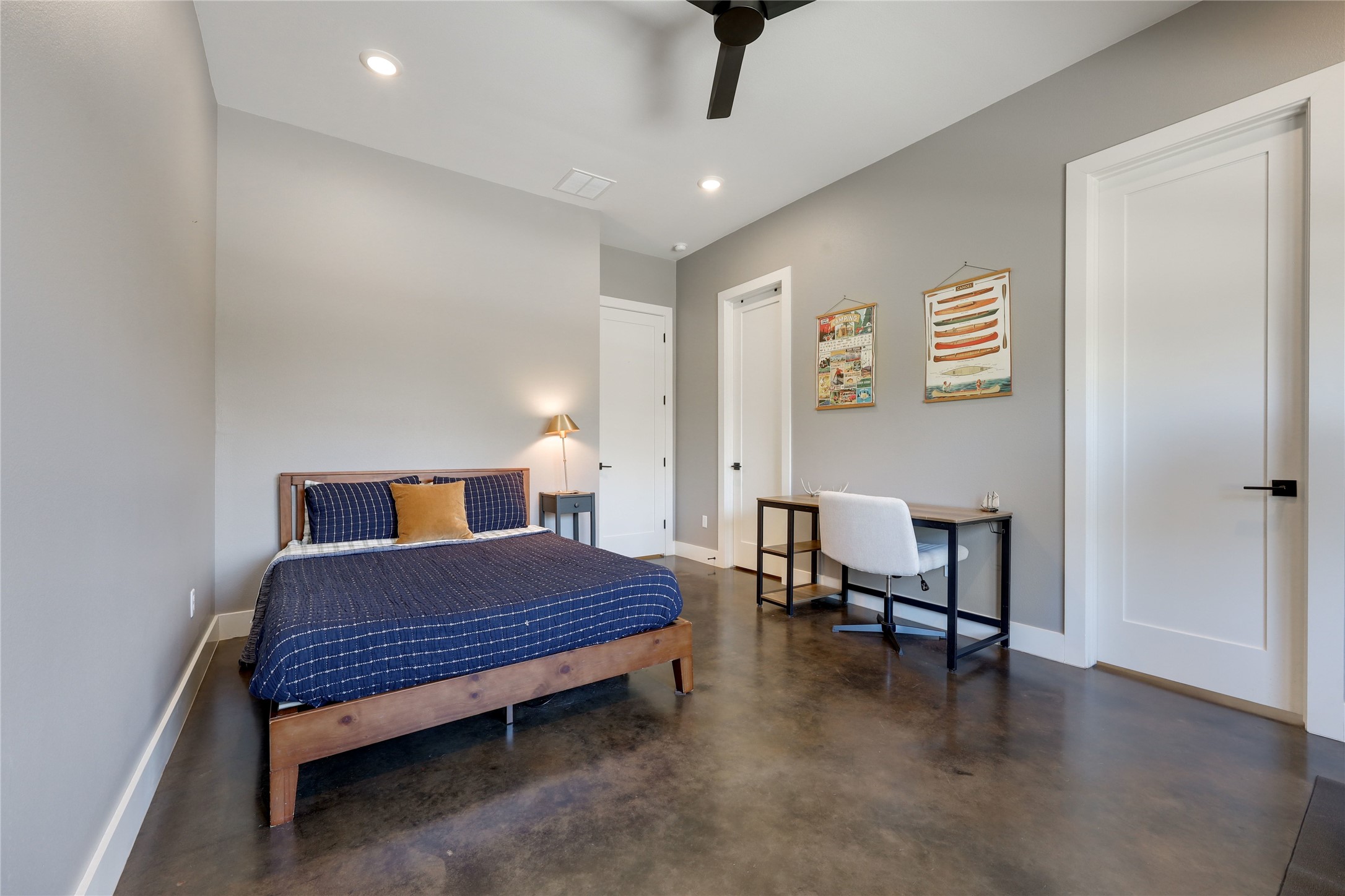 329 Calvary Cove Dripping Springs, TX 78620 - Photo 26 of 40 a bedroom with a bed and a chandelier